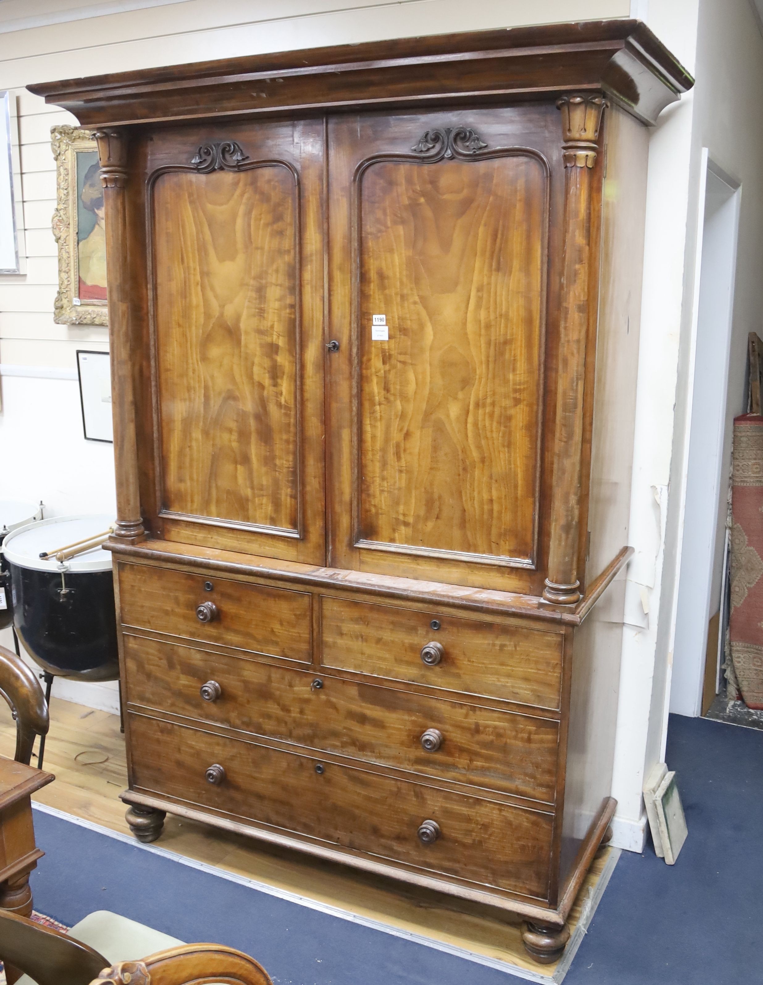 A William IV mahogany linen press, raised over two short and two long drawers, width 132cm, depth 60cm, height 213cm